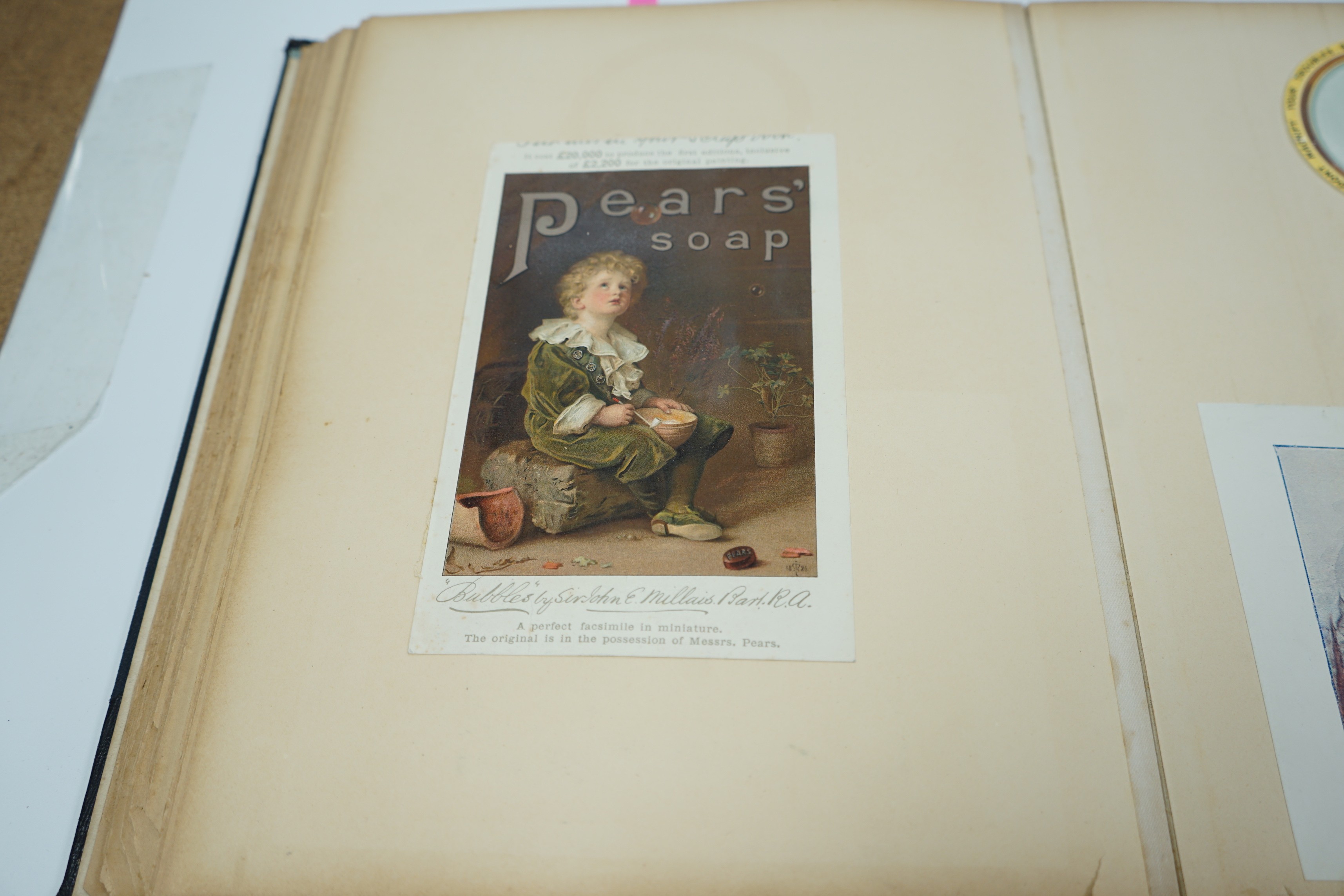 An early 20th century postcard album and a similar advertising album